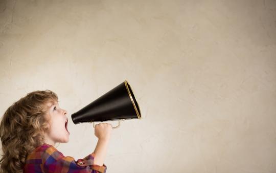 young child shouting into a bull horn