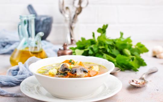 soup with vegetables and mushrooms and fresh greens