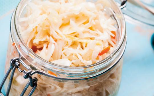 sauerkraut in glass jar on a table