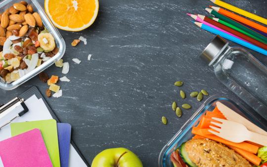 lunches in containers on a school desk