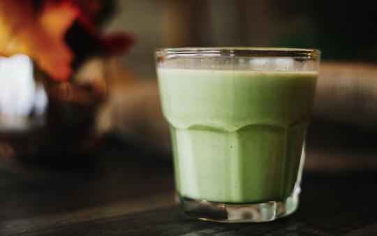 A green smoothie in a glass jar