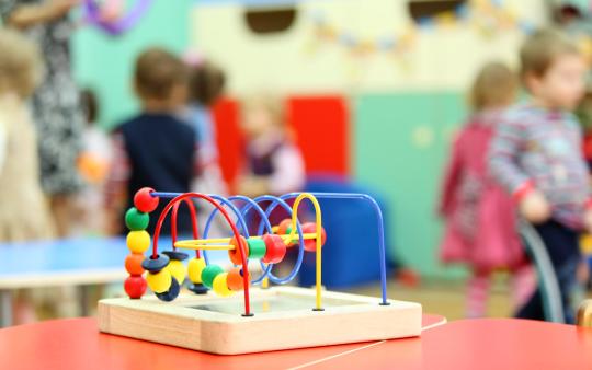 A child's toy sits on a school desk