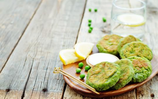 An image of fritters made with chickpea flour, onions, and garlic on a plate.