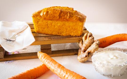 carrot cake loaf surrounded by ingredients, like carrots