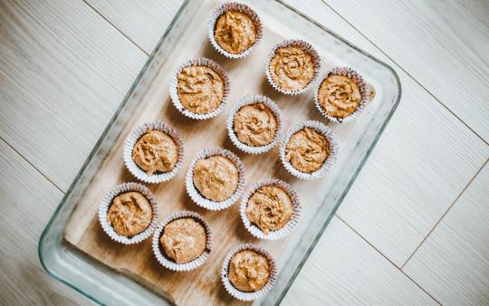 a tray of uncooked muffins 