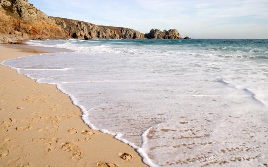 a beach with a rolling tide coming on shore