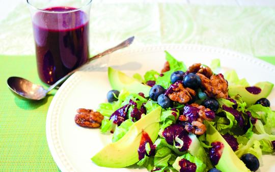 plate of salad with avocado, blueberries and pecans