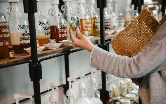 A shopper examines reusable product bottles