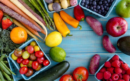 colorful fruits and veggies on a table forming a circle