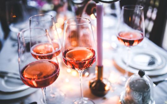 filled wine glasses on a dinner table