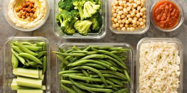 portions of healthy food laid out in a grid of glass containers