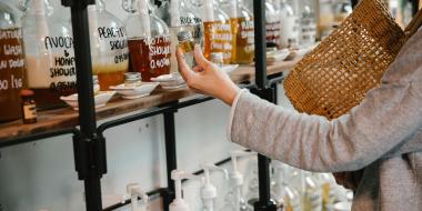 A shopper examines reusable product bottles